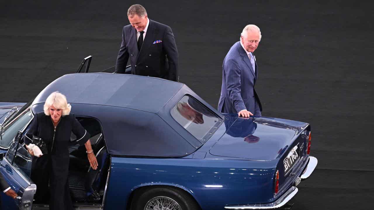 King Charles and Queen Camilla arrive in a car