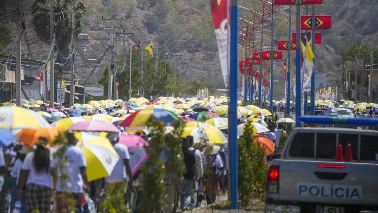 Faithful arrive for a mass presided over by Pope Francis in East Timor