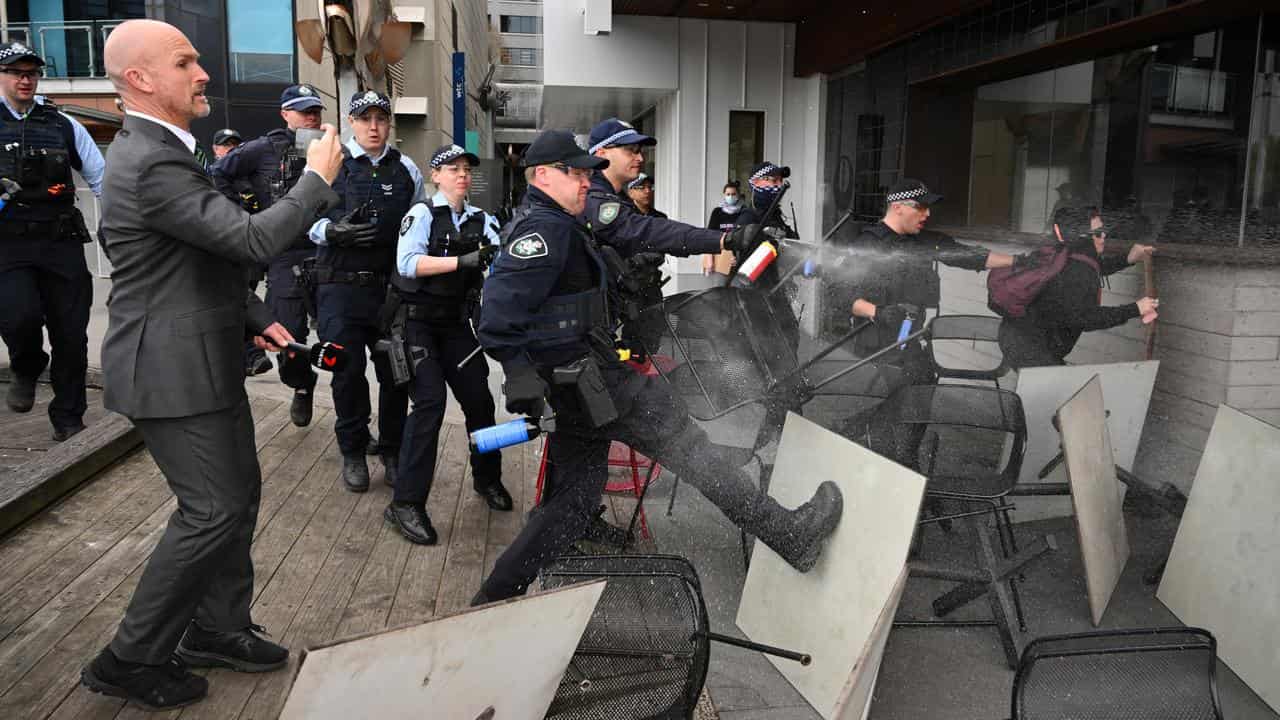 Police deploy pepper spray against anti-war protesters in Melbourne.