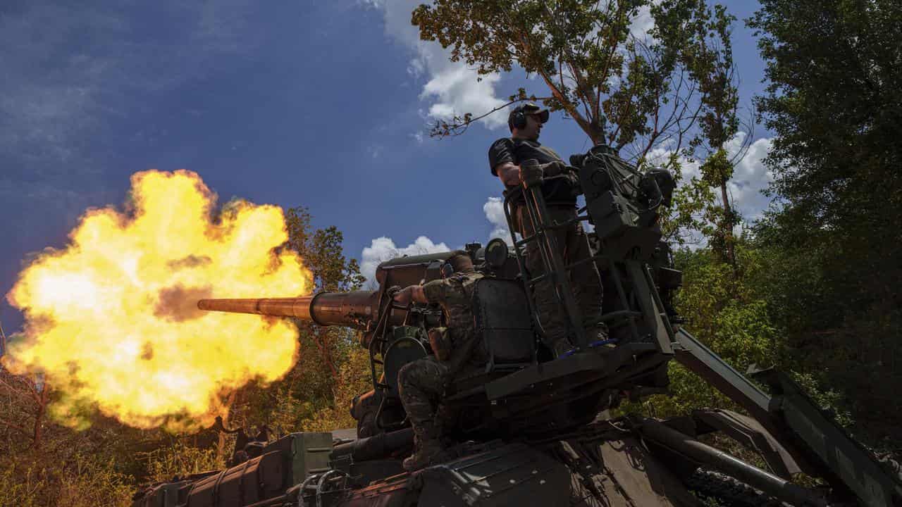 Ukrainian troops fire a self-propelled howitzer in the Donetsk region