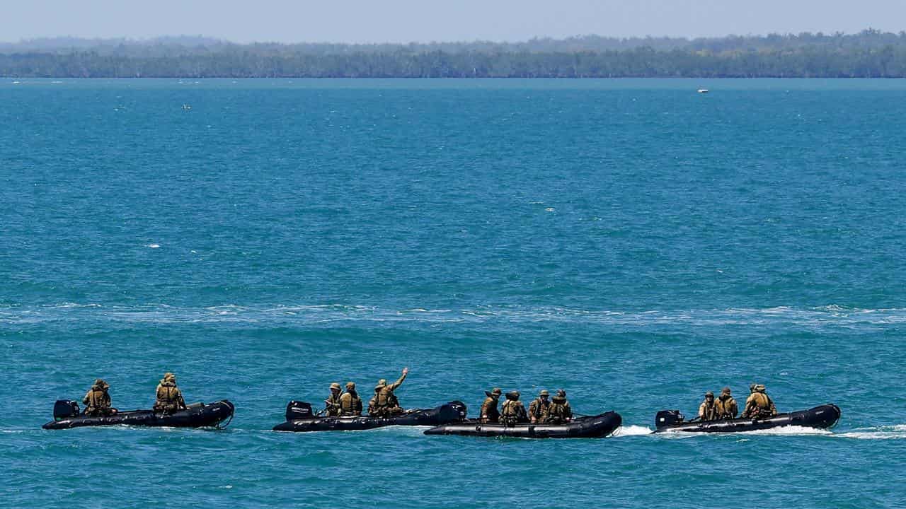 Soldiers in rigid inflatable boats