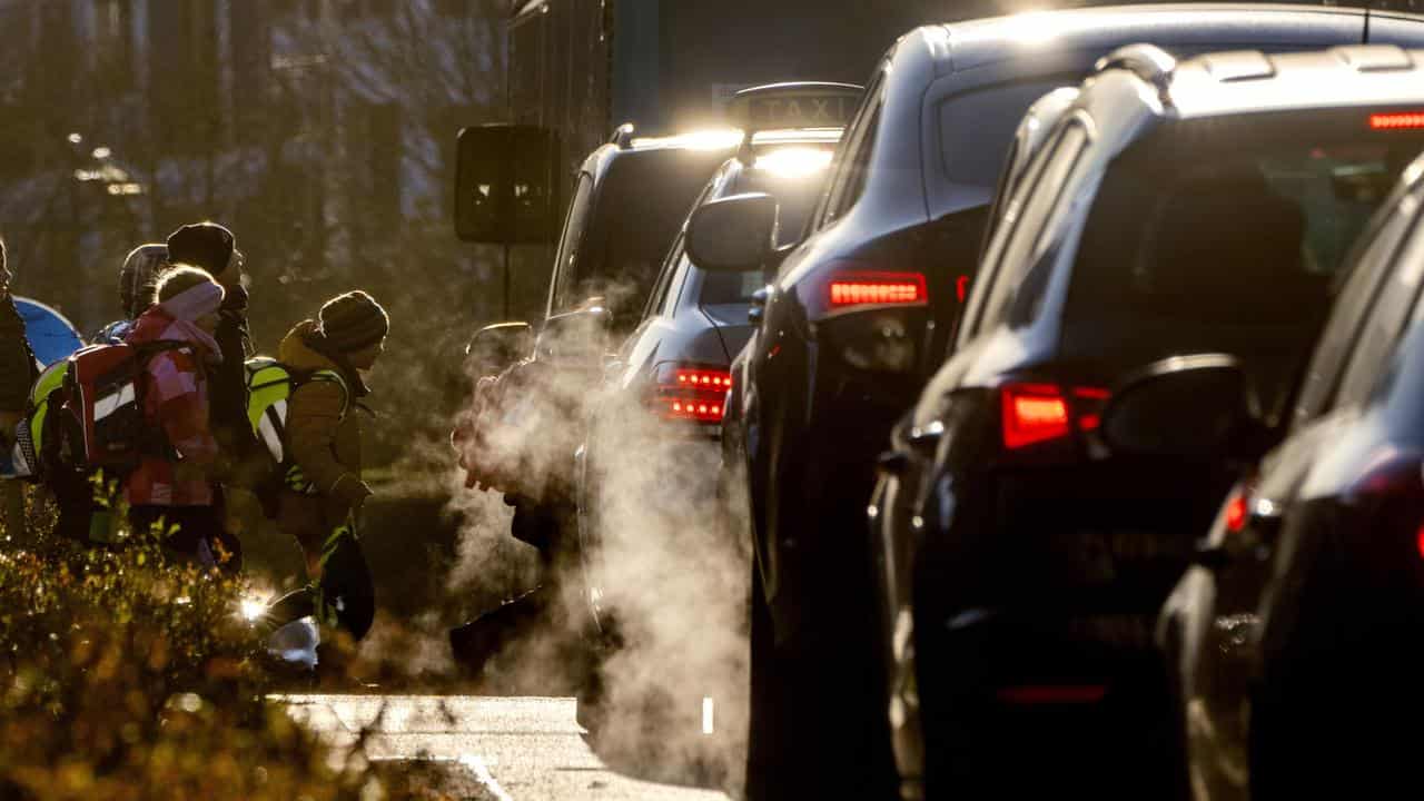 Cars emitting exhaust fumes, Germany.