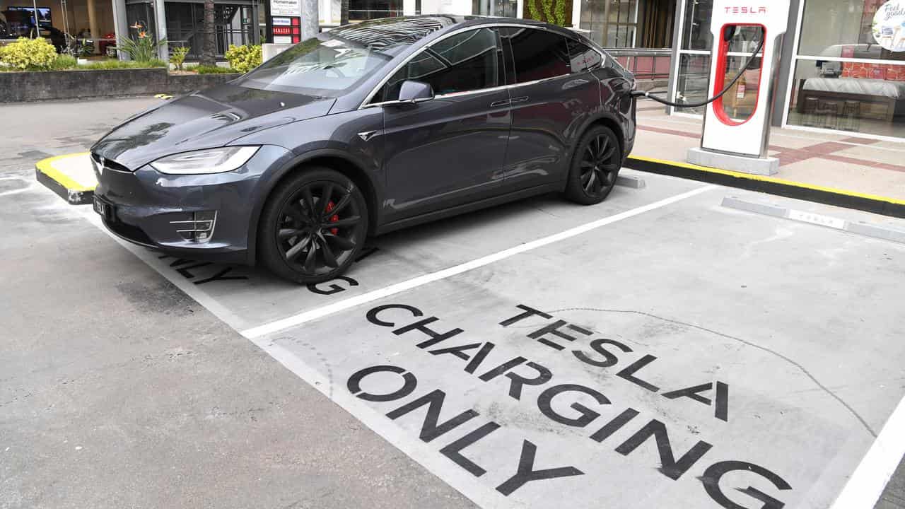 A Tesla model X car being charged