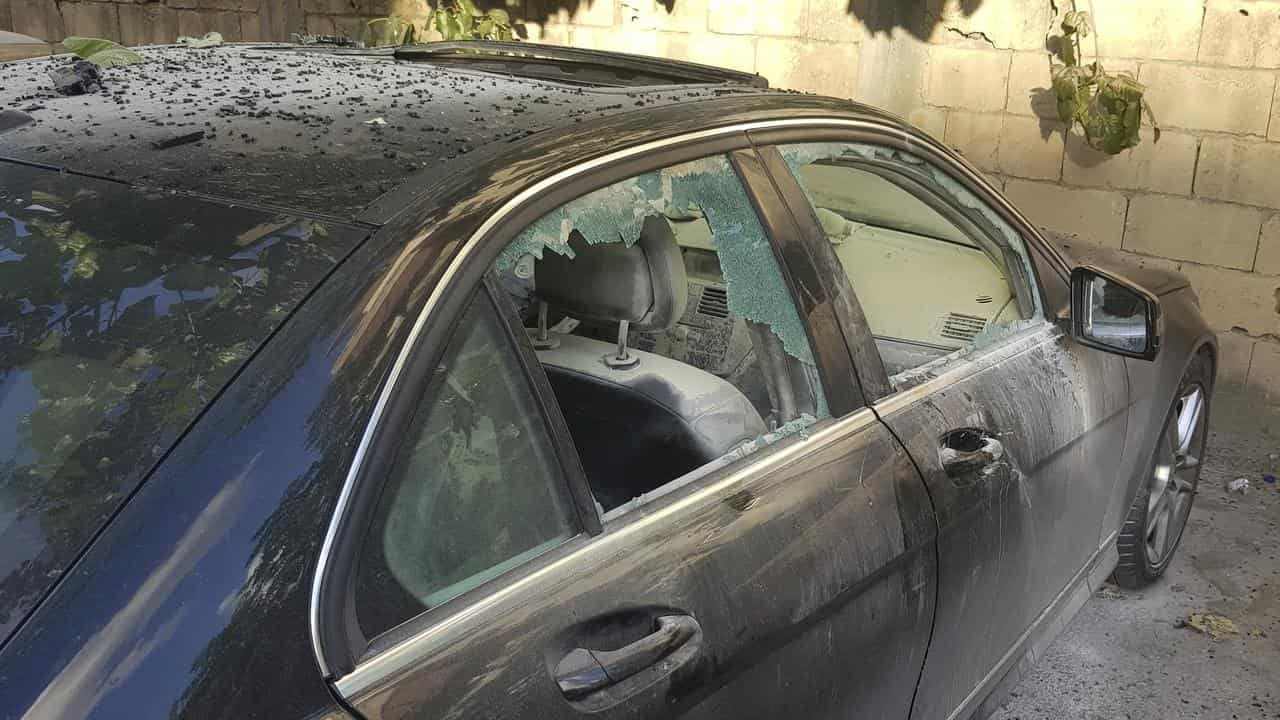 Partly damaged car in Sidon