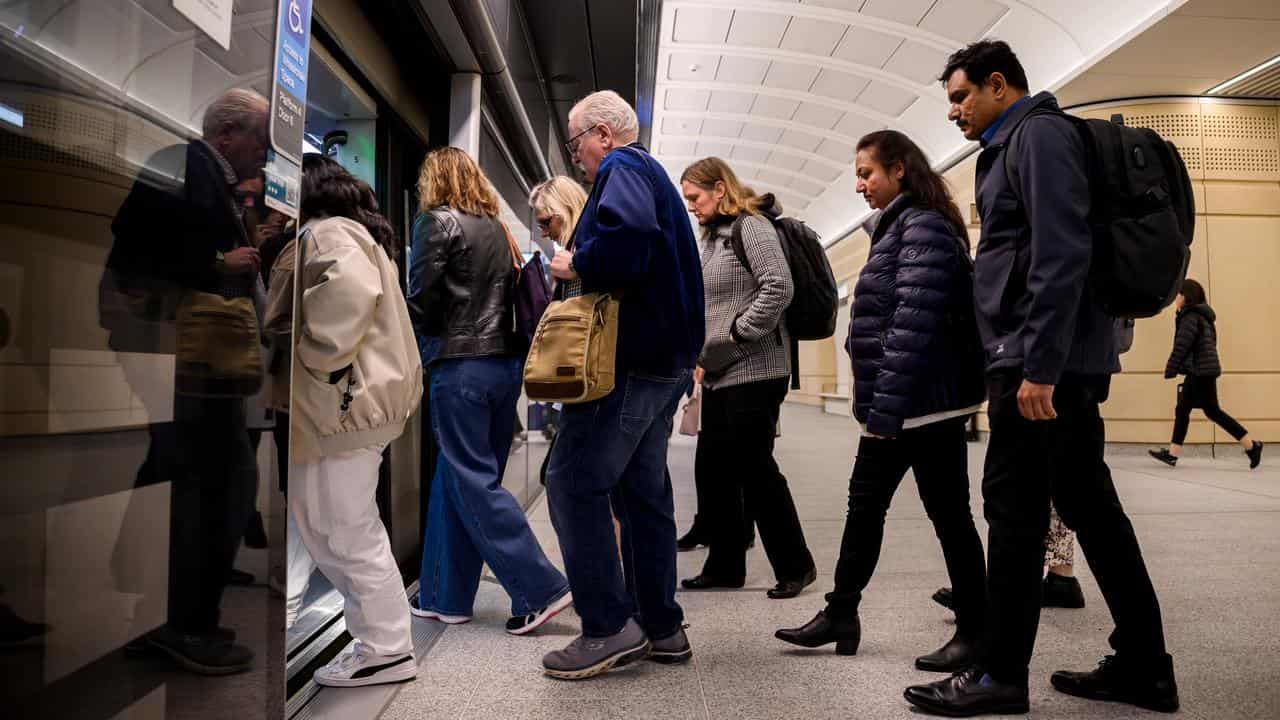 Commuters enter a train in Sydney (file image)