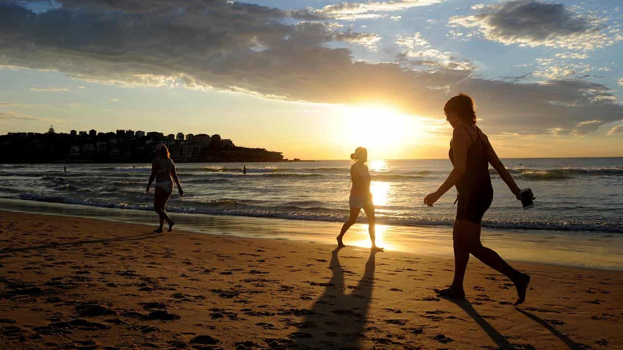 People walk on a beach (file image)