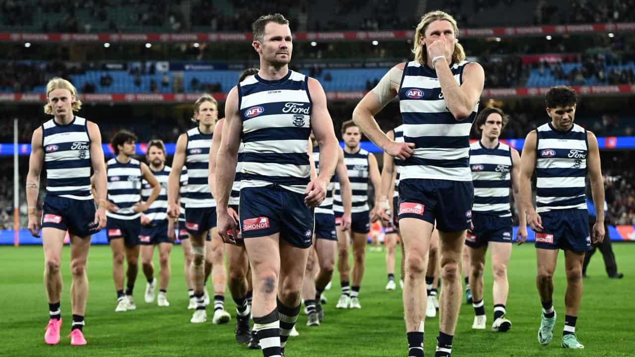 Geelong players leave MCG after defeat.