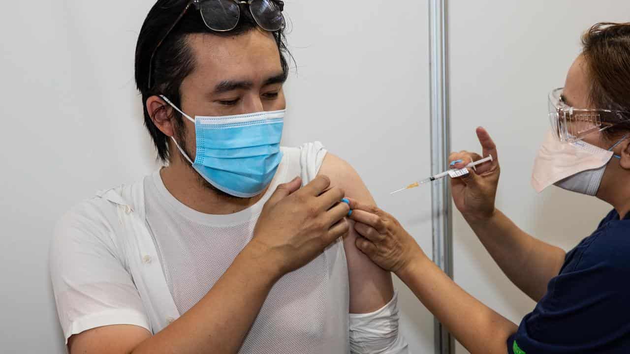 A health worker administers the COVID-19 vaccine 