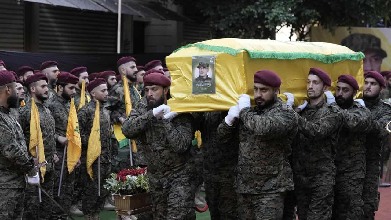 Hezbollah members carry the coffin of Hezbollah commander Ibrahim Akil