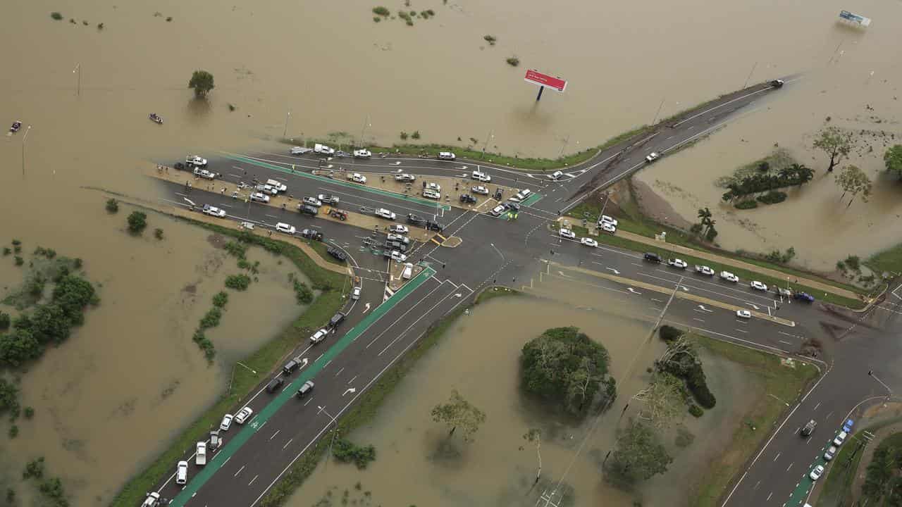 Floodwater engulfs the Bruce Highway in Townsville