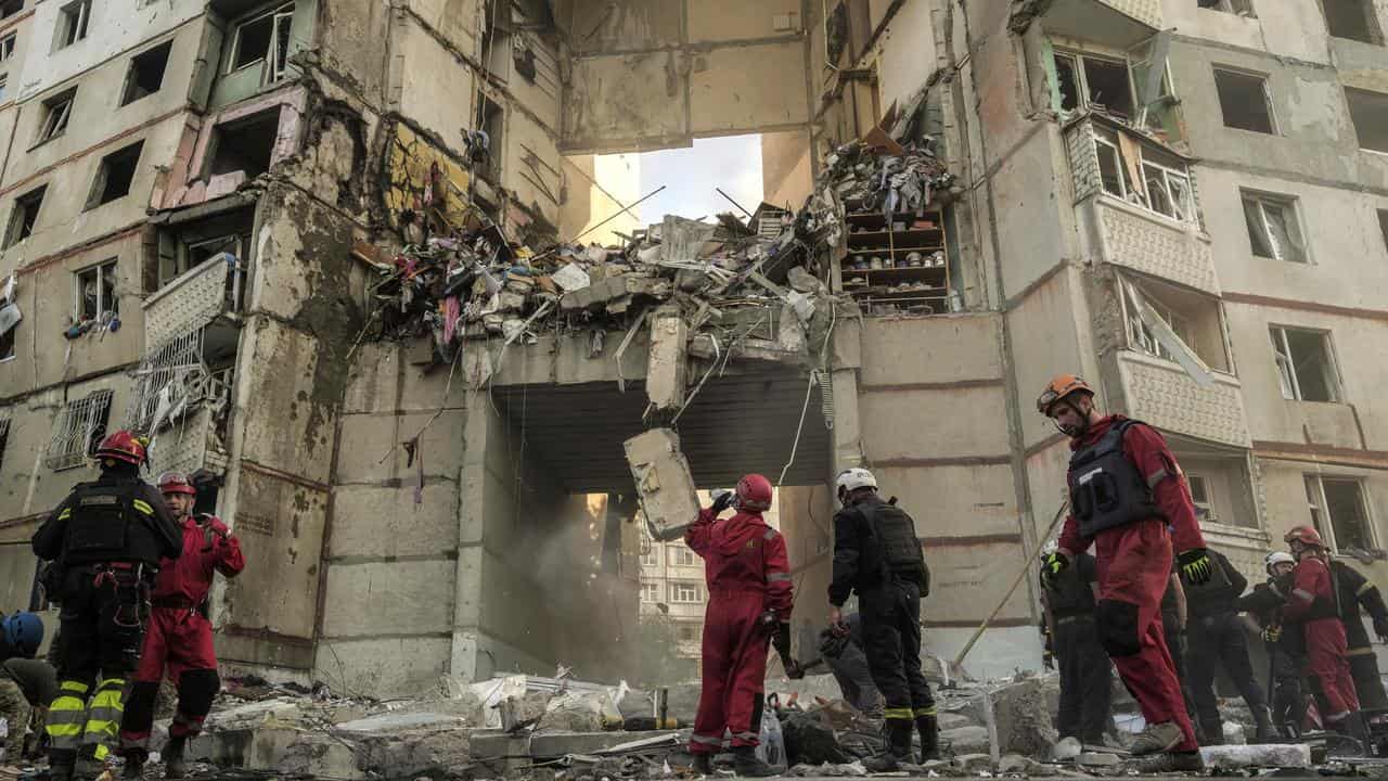 Ukrainian rescuers inspect damage after shelling in Kharkiv