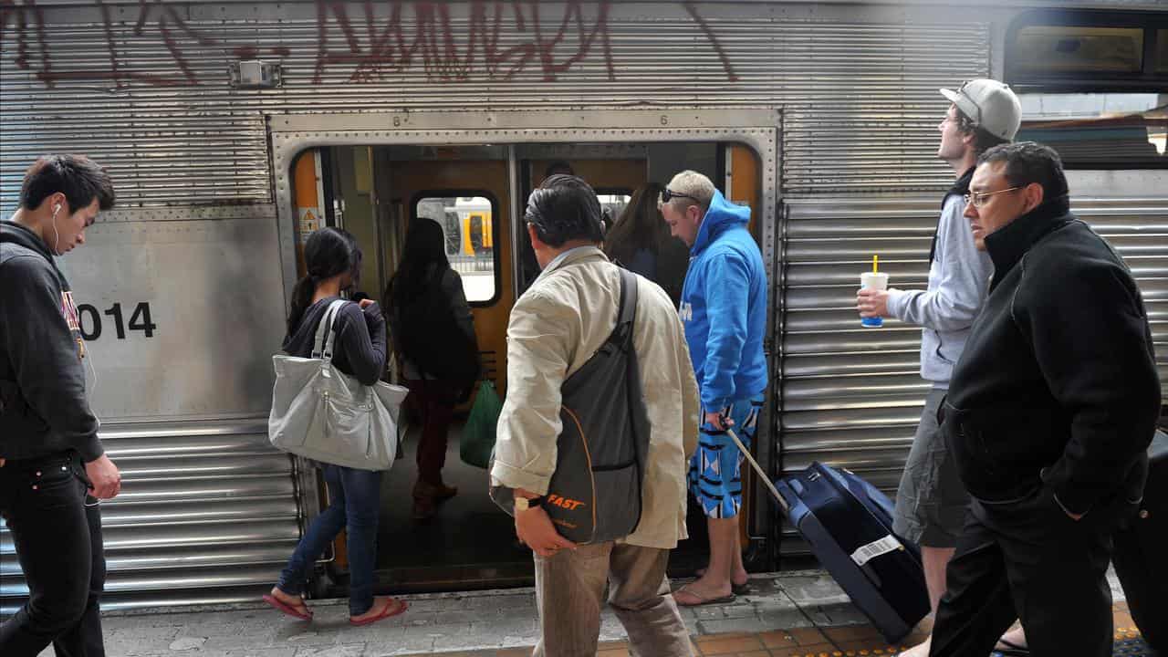 Sydney commuters board a train (file image)