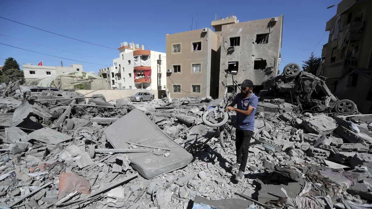 Man at the site of an Israeli strike in Saksakieh, Lebanon