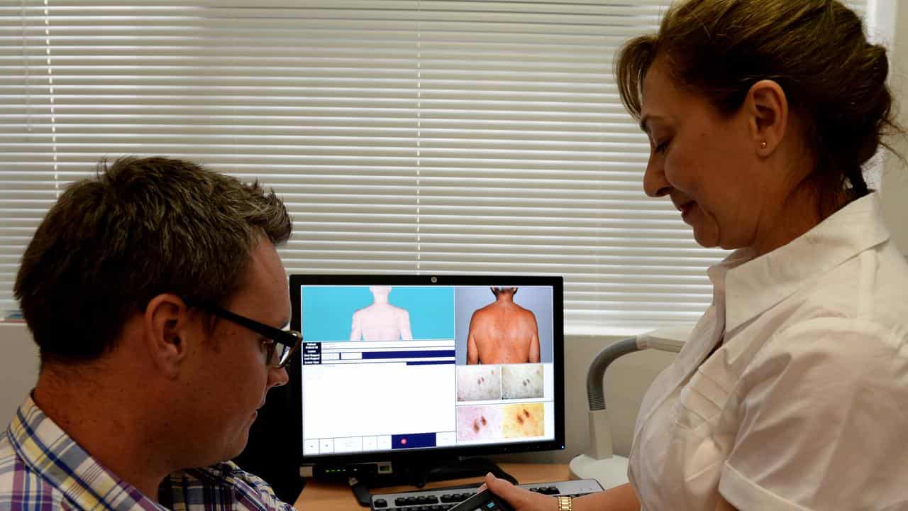 A patient being checked for skin cancers