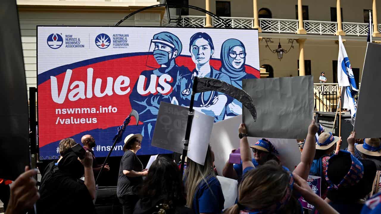 NSW nurses and midwives hold placards as they strike in Sydney