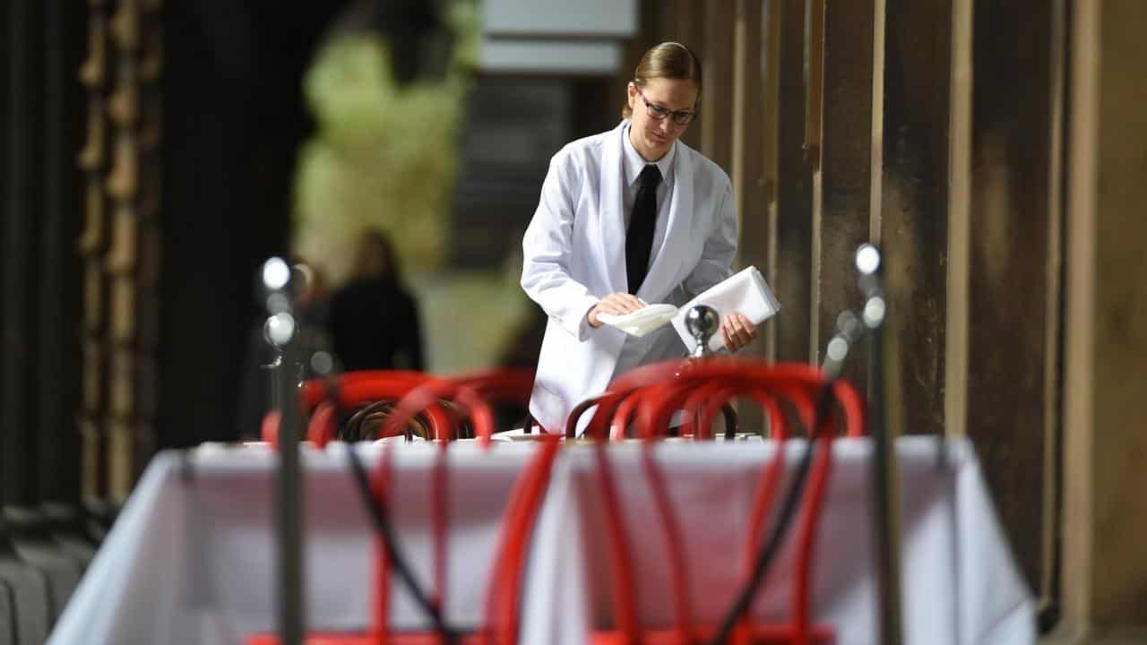 A waitress sets a table at a restaurant (file image)