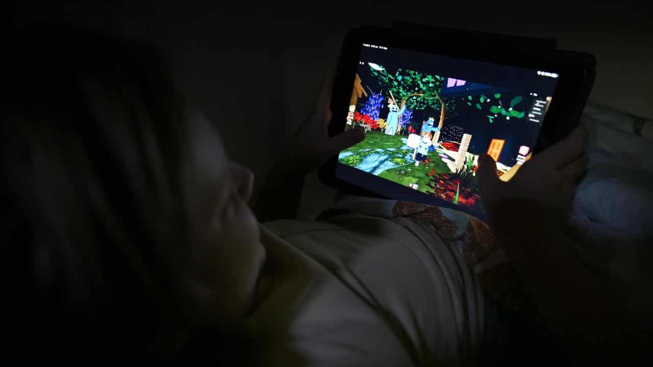 Child playing on a tablet device.