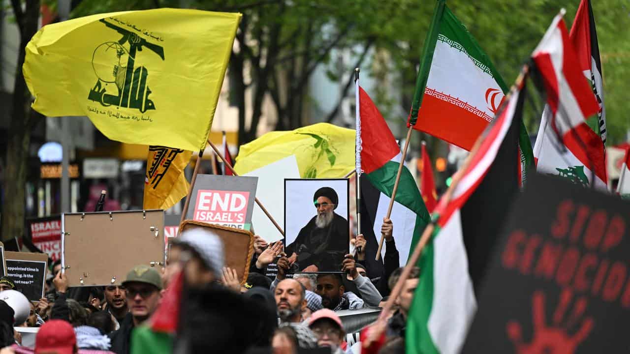 Hezbollah and Palestine flags at a rally