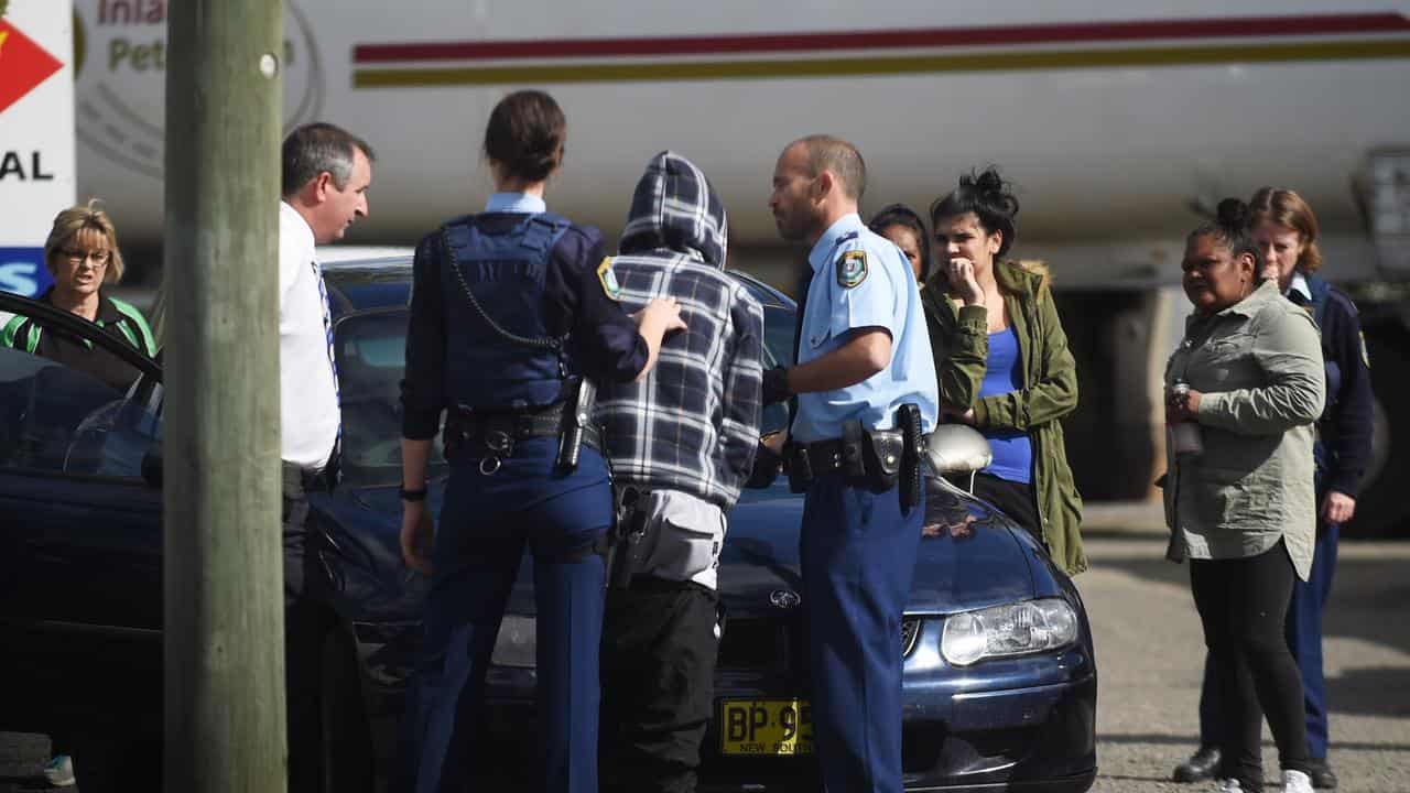 Police officers question and later release a youth