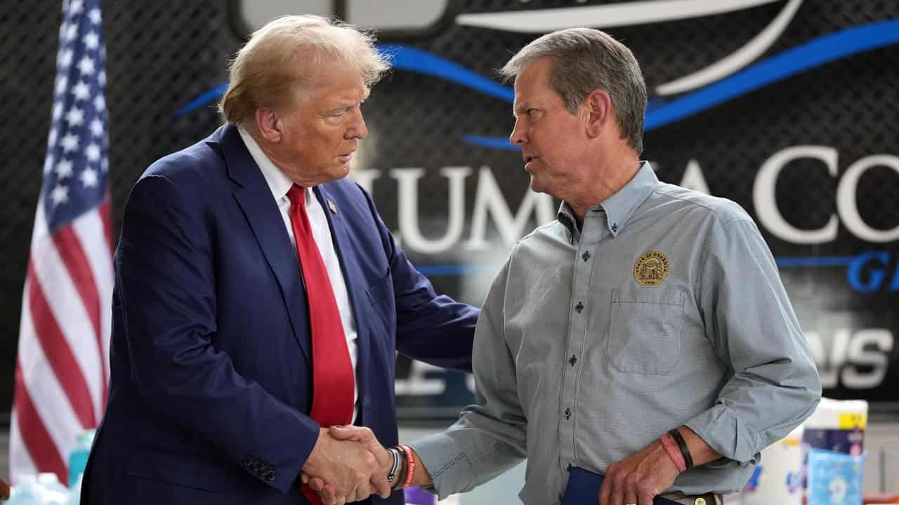 Donald Trump and Governor Brian Kemp at a storm relief centre in Evans