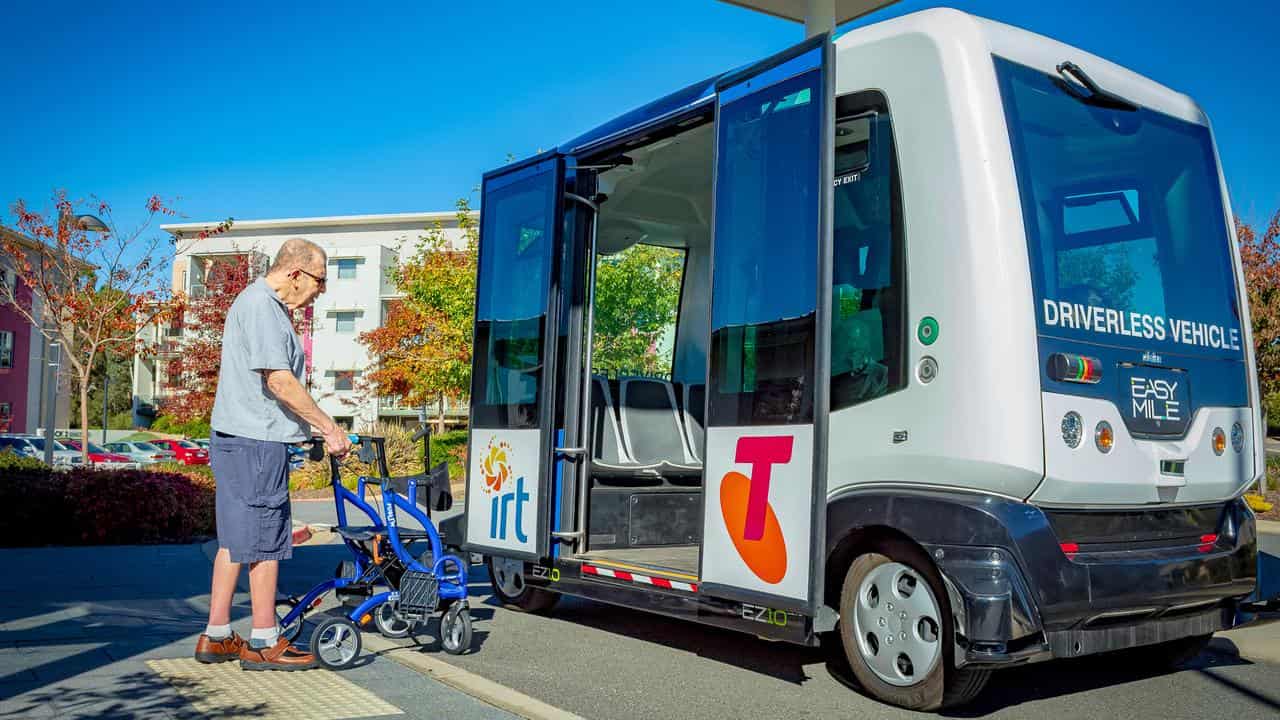 Elderly man boarding a driverless bus (file)