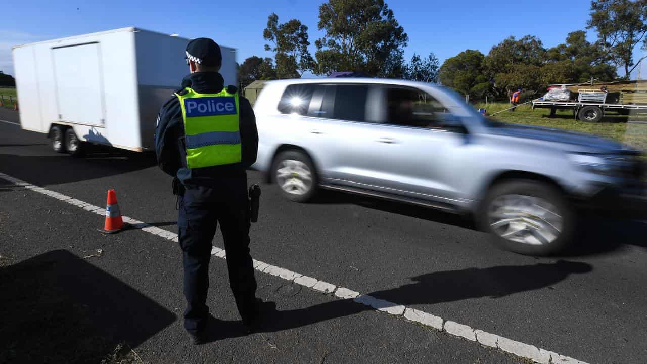 A Victorian Police officer at a vehicle checkpoint (file image)