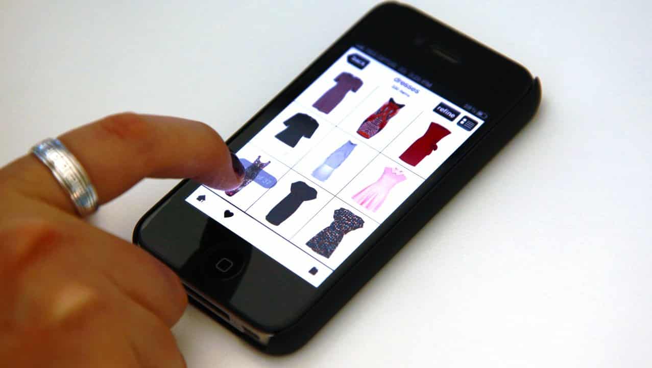 A woman browses an online clothing store.