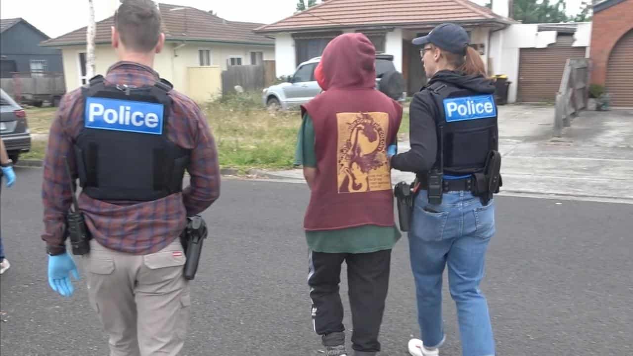 Victoria police officers arrest a protester