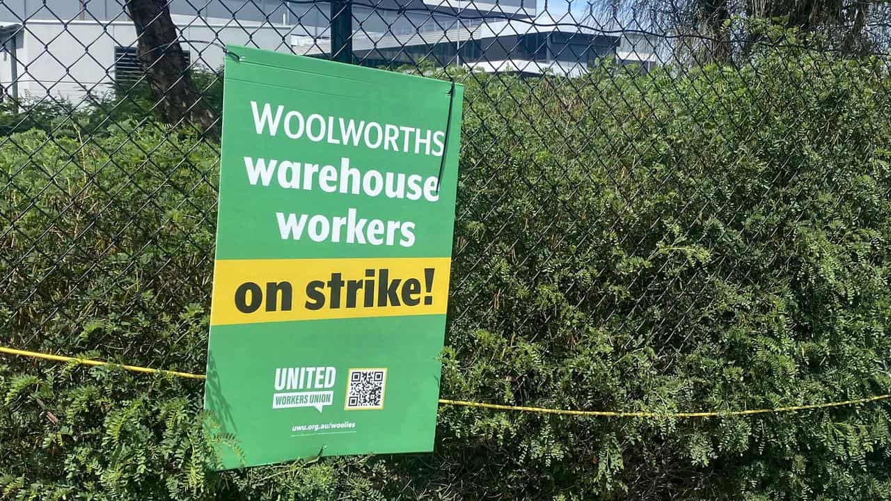 A placard on a fence at a Woolworths warehouse