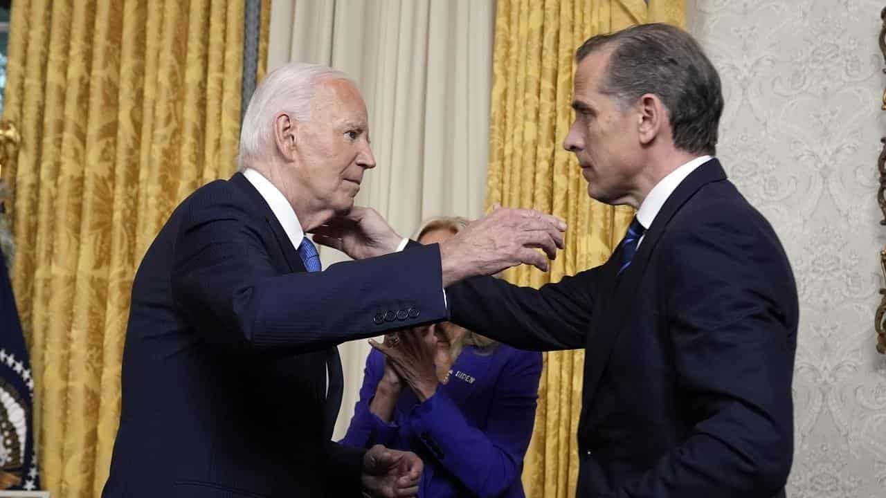 US President Joe Biden hugs his son Hunter in the Oval Office