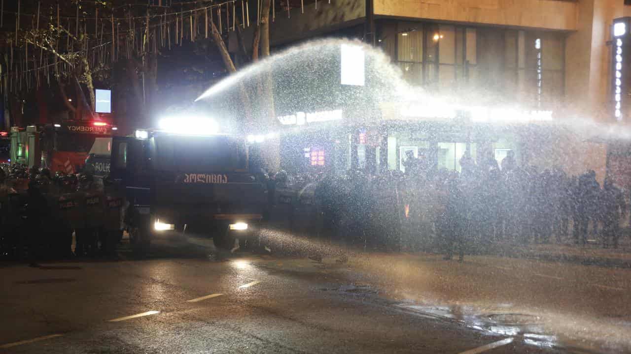 Police use a water cannon against demonstrators rallying in Tbilisi