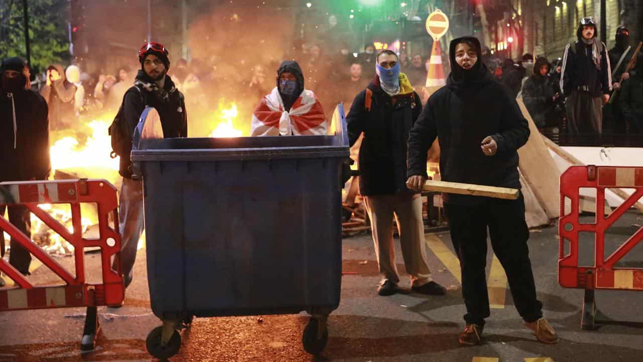 Demonstrators stand at a barricade in Tbilisi, Georgia