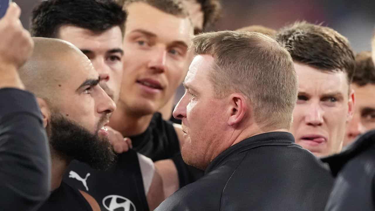 Carlton coach Michael Voss (centre),  Patrick Cripps and Sam Walsh.