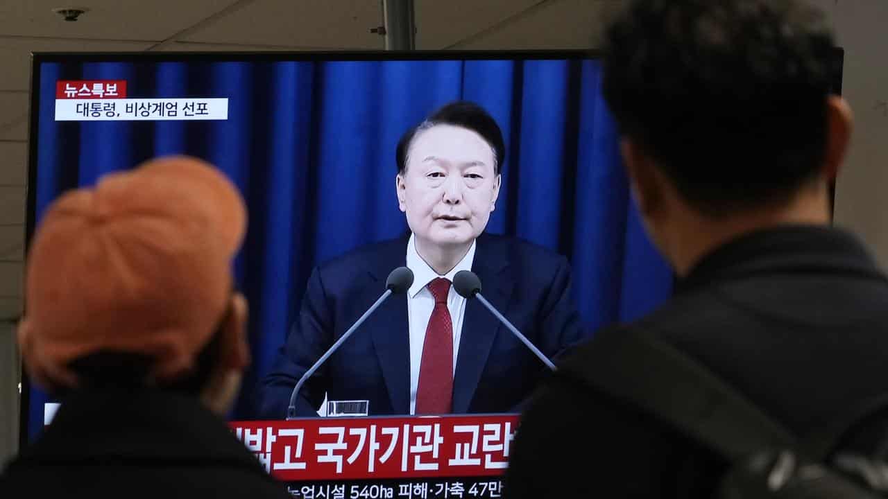 TV screen in Seoul showing President Yoon Suk-yeol's address