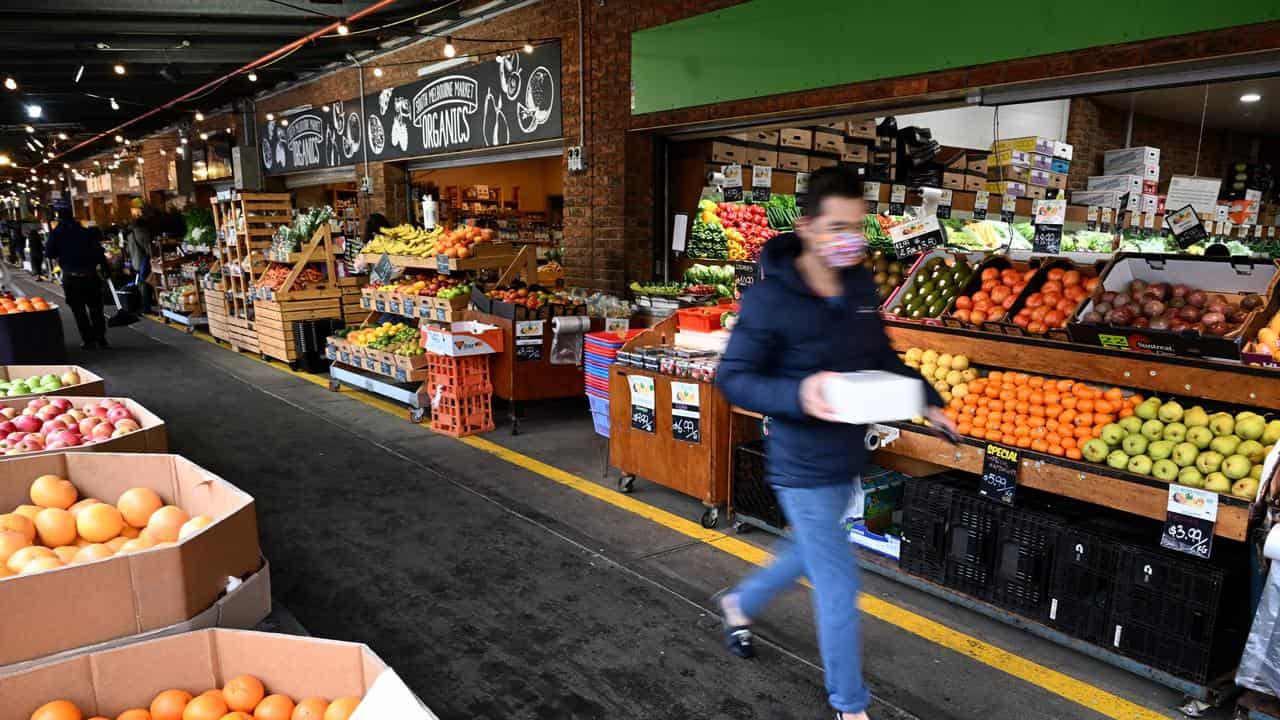 Person walking past market