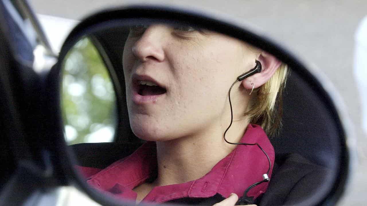 A driver chats on their phone (file image)