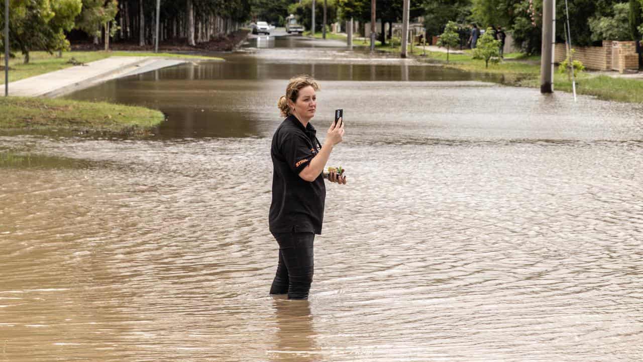 Woman in floodwater in Seymour