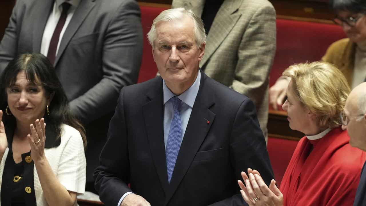 Prime Minister Michel Barnier gets applause after the confidence vote