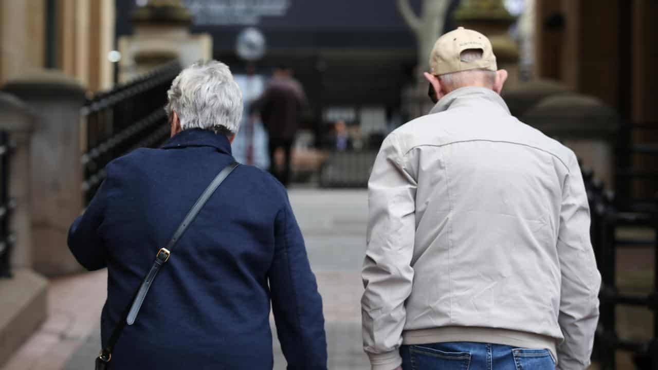 Elderly people walk down a street in Sydney