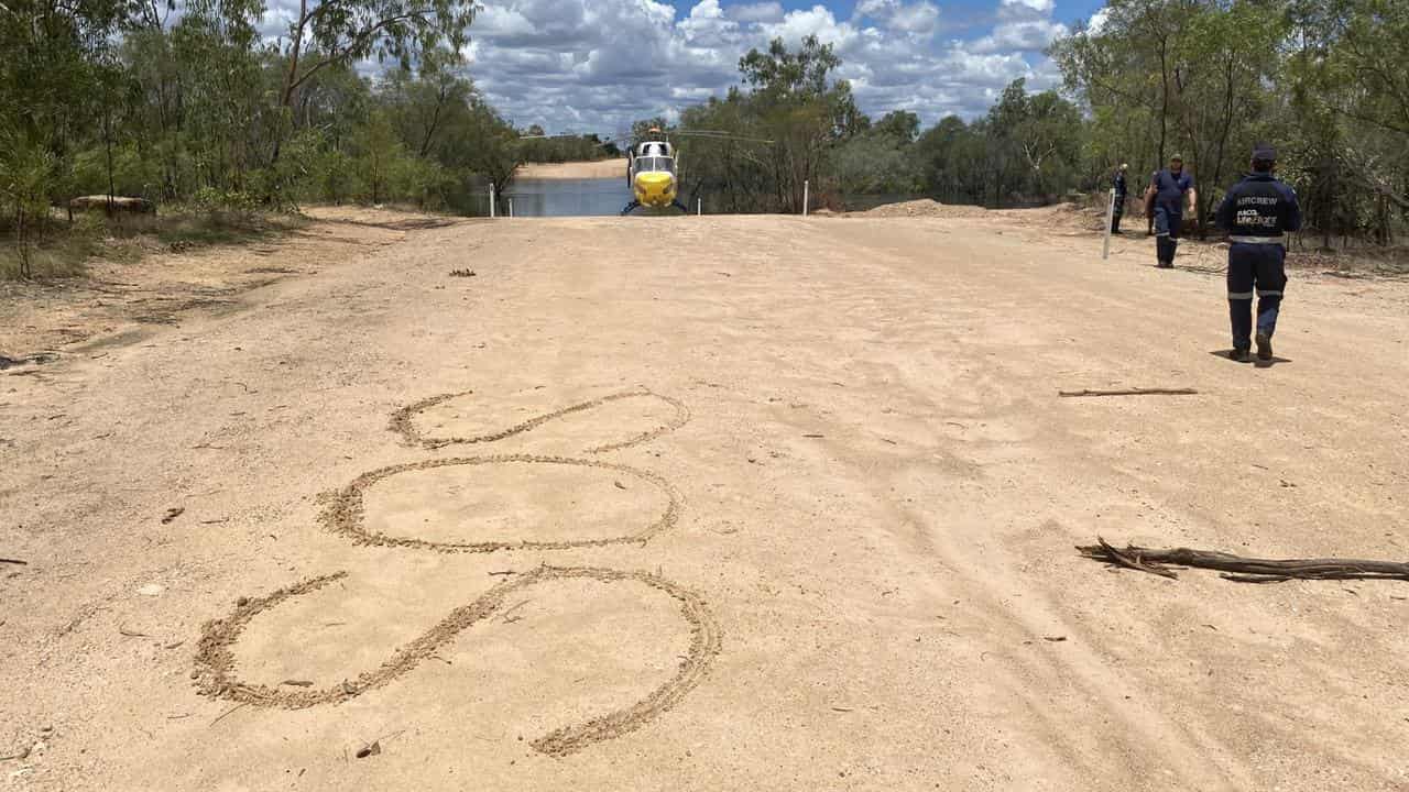 SOS sign in the sand