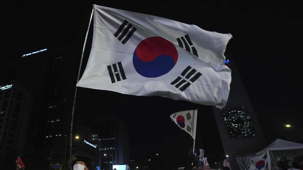 People wave flags during a rally held by conservative groups