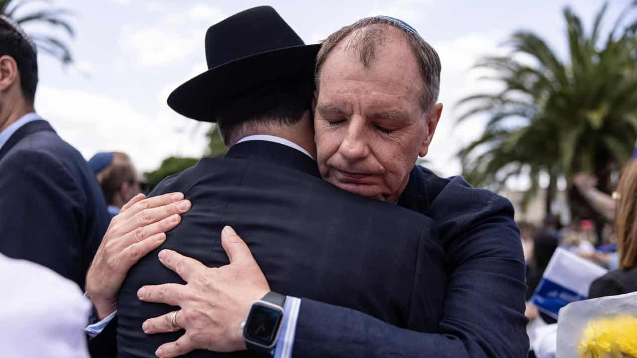 MP David Southwick hugs a member of the Jewish community 