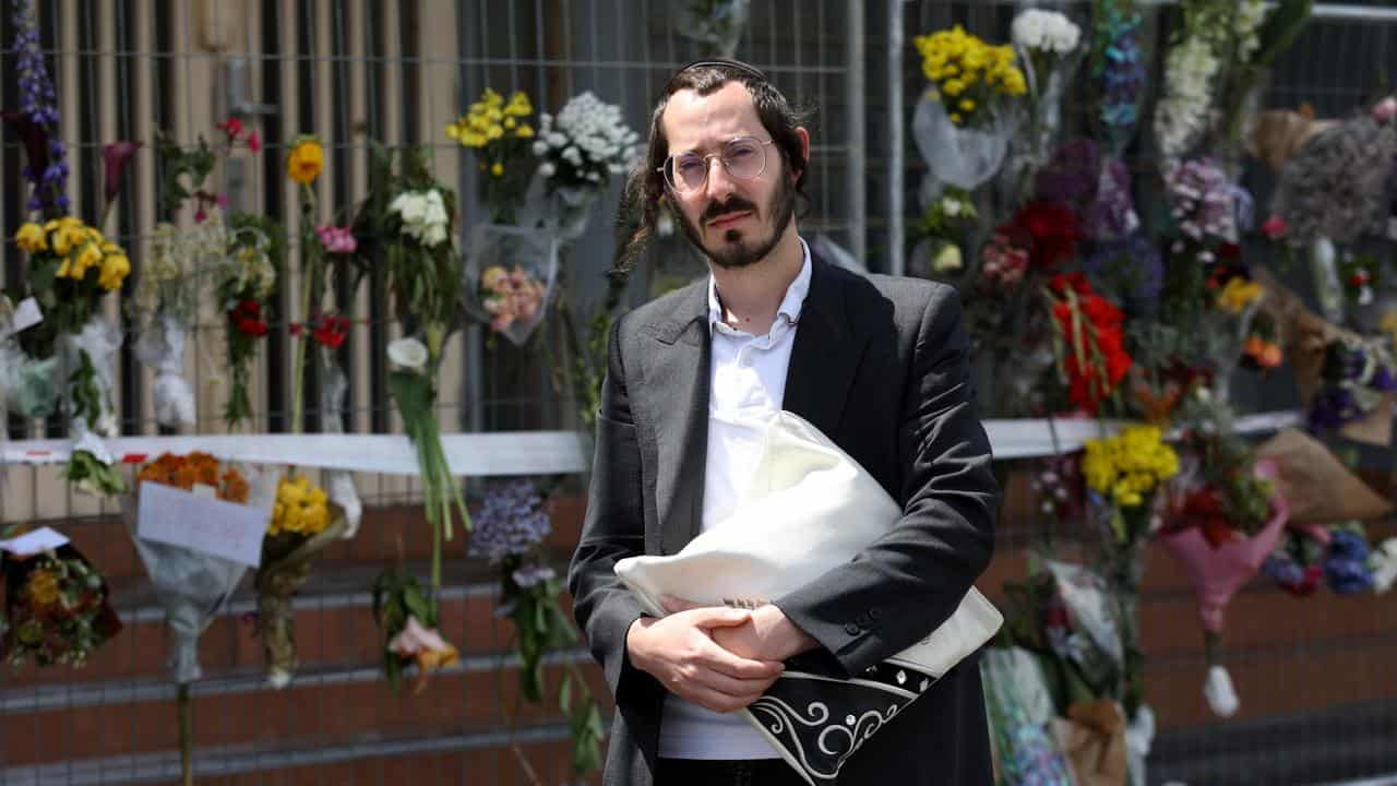 Sam in front of flowers at synagogue