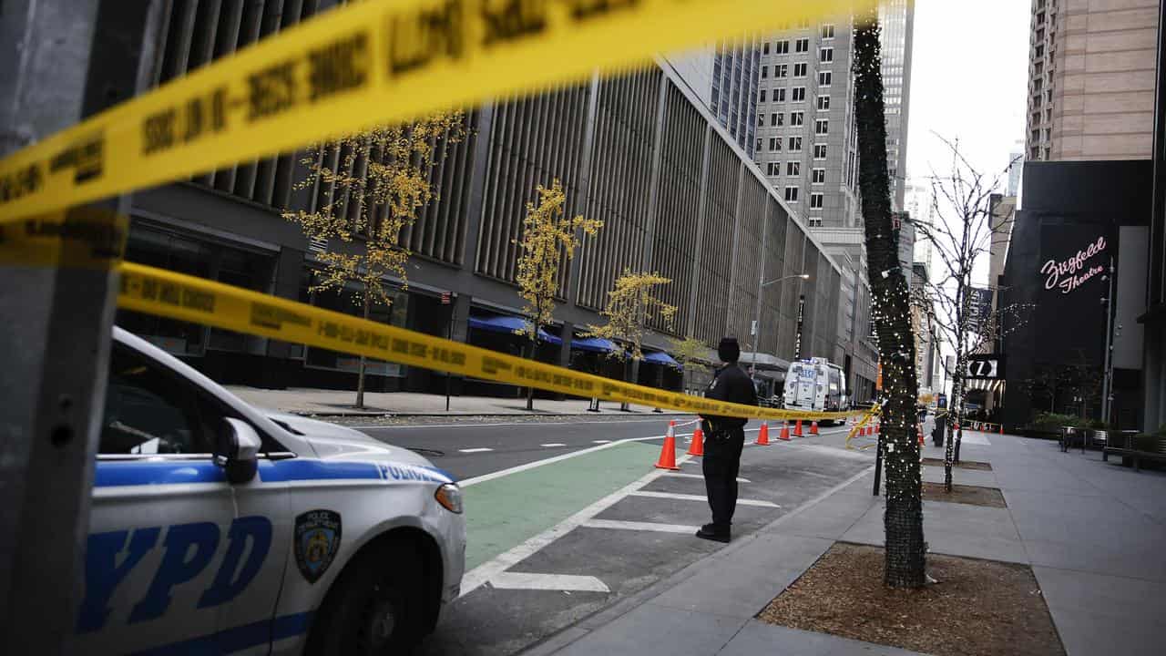 Police officer and police tape at the scene of a shooting in New York