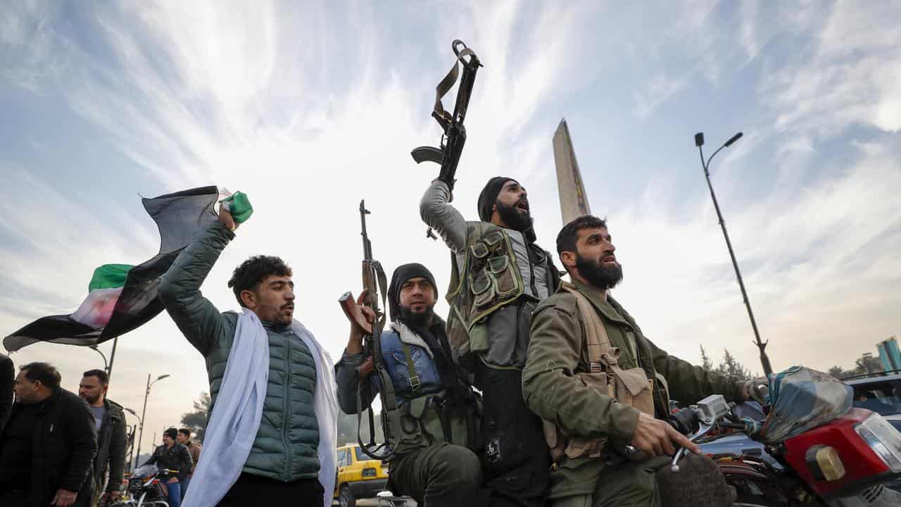 Syrian opposition fighters celebrate government collapse in Damascus