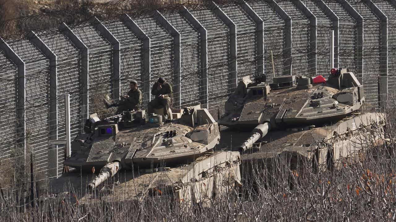 Israeli tanks at the border fence dividing the Golan Heights and Syria