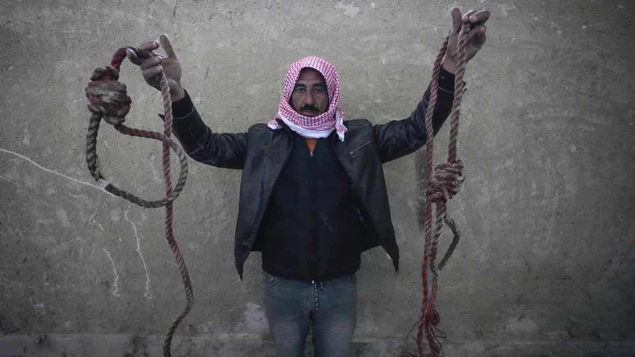 A man shows two nooses found in the infamous Saydnaya military prison