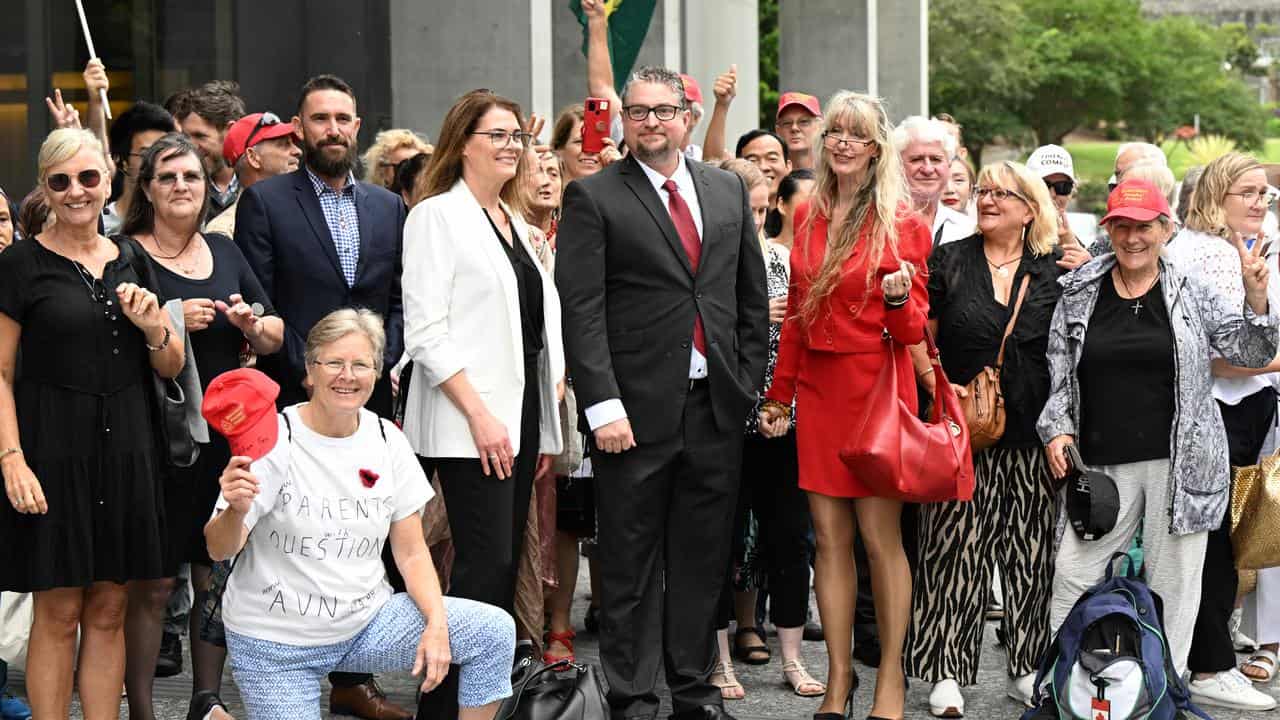 Dr William Bay and supporters outside the Brisbane Supreme Court.