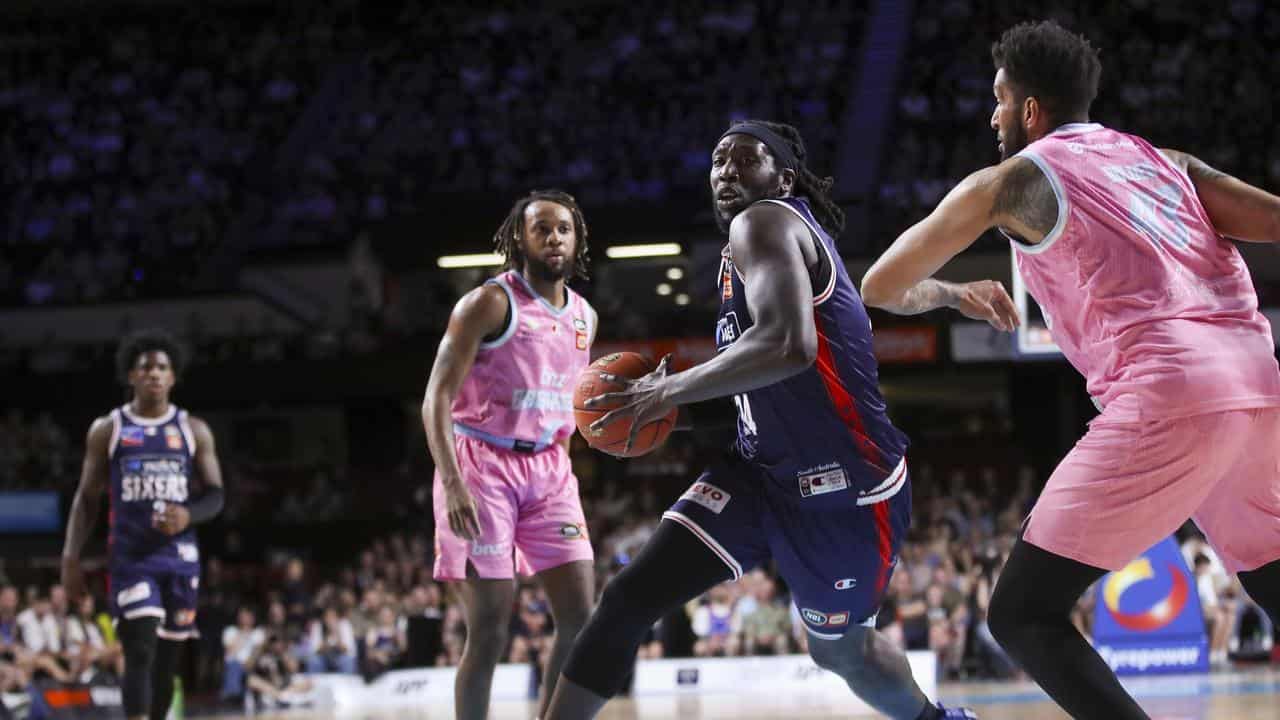  Montrezl Harrell (centre) battles with the Breakers' Jonah Bolden.