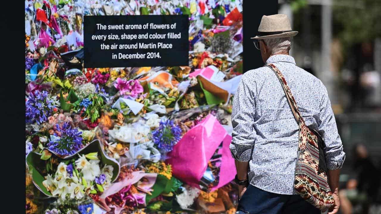 Photos showing the sea of flowers left at Martin Place